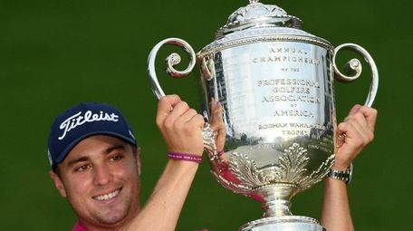 Justin Thomas of the United States poses