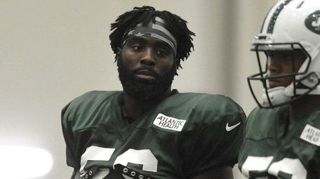 Demario Davis #56, left, practices during New York