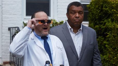 Dr. Dean Hart, left, Holding special glasses to