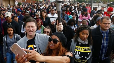 As Phoenix Mayor Greg Stanton, left, holds the