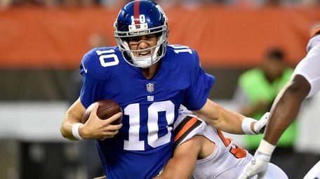 Giants quarterback Eli Manning is sacked by Browns