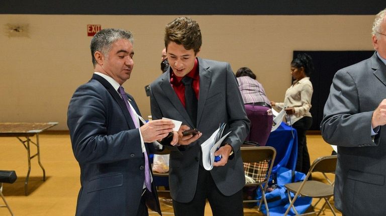 Job seeker John Blackall, center, of Holbrook, speaks