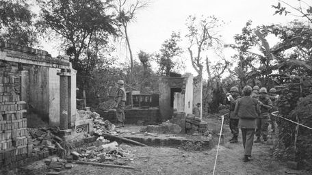 American soldiers look over the remains of a