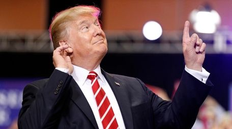 President Donald Trump reacts to the song as