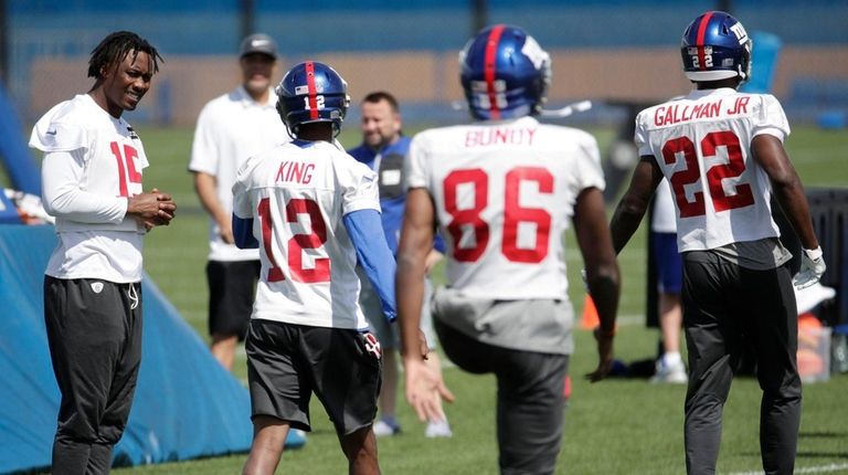 Giants receiver Brandon Marshall, left, watches as teammates