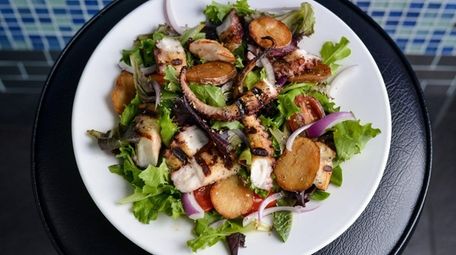 Grilled octopus salad, with tomato, onion, and potato