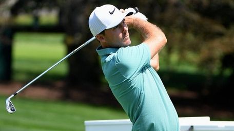 Russell Henley tees off at the 17th during