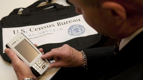 A census worker in Garden City examines new