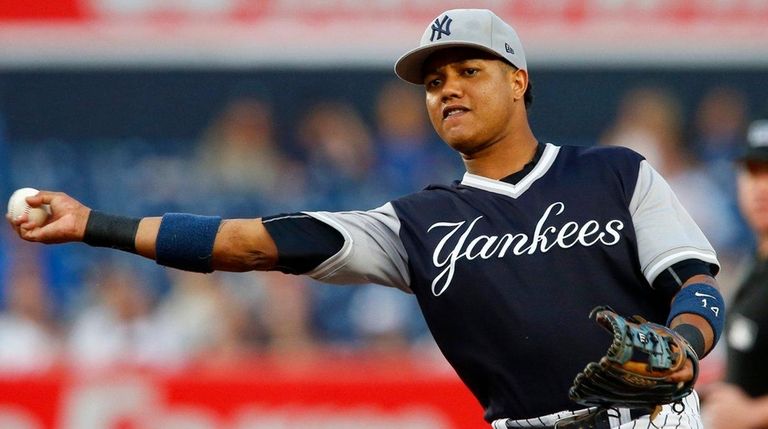 Starlin Castro of the Yankees throws for an