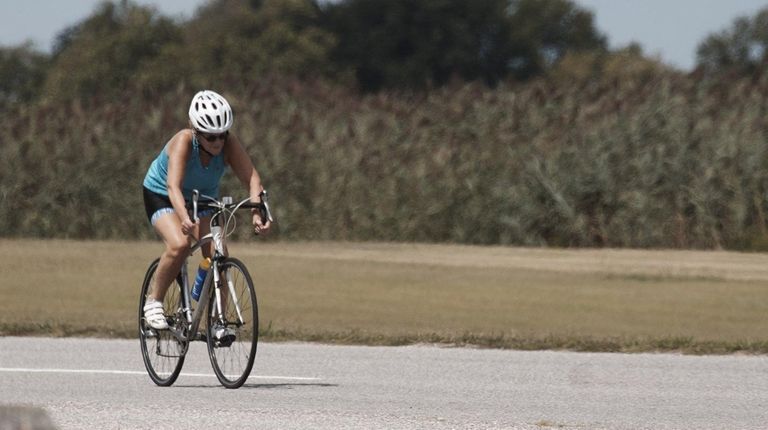 A woman rides on a bicycle at Hecksher