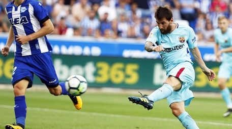 FC Barcelona striker Lionel Messi scores the 2-0