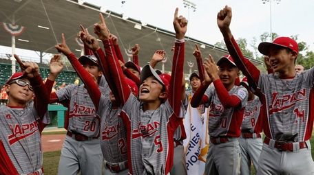 Members of Japan celebrate after defeating the Southwest