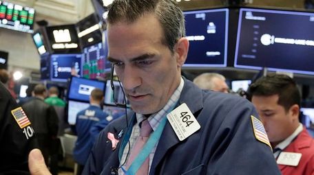 Trader Gregory Rowe works at the NYSE, Aug.