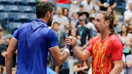 Marin Cilic, of Croatia, left, shakes hands with