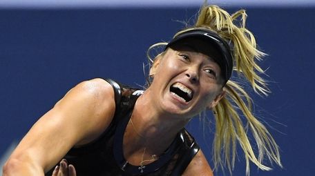 Maria Sharapova serves to Simona Halep during first-round