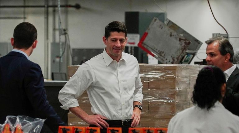 House Speaker Paul Ryan, center, tours a packaging