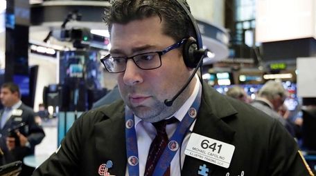 Trader Michael Capolino works at the NYSE, Aug.