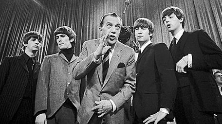 Show host Ed Sullivan, center, with members of