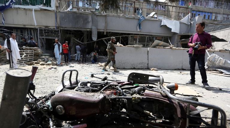 Debris litters the front of Kabul Bank after