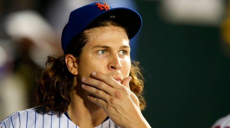 Mets pitcher Jacob deGrom looks on after he was