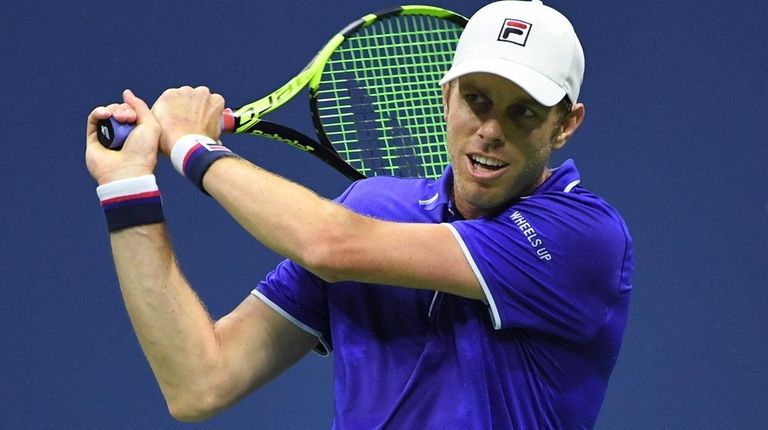 Sam Querrey returns a shot to Kevin Anderson