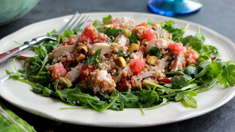 A salad made with bulgur wheat, pistachios, tomatoes,