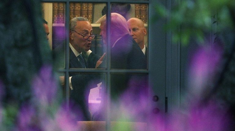 Senate Minority Leader Chuck Schumer talks with President