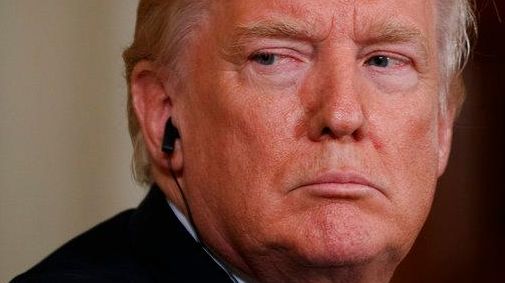 President Donald Trump listens as the Emir of