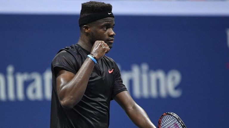 Frances Tiafoe reacts after he wins the fourth