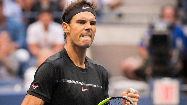 Rafael Nadal pumps his fist after winning the