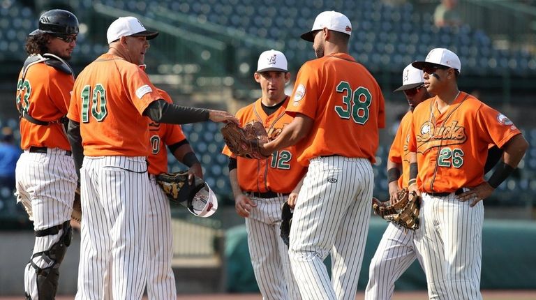 Ducks manager Kevin Baez hands the ball to