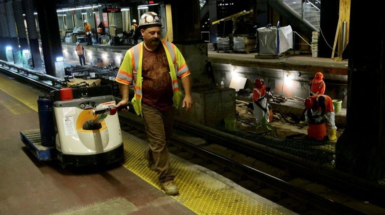 Workers replace rails, ties and concrete on Track