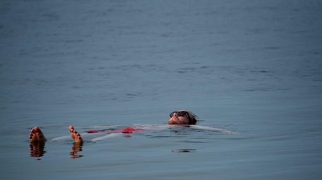 George Talboys, 27, of Oyster Bay, floats in