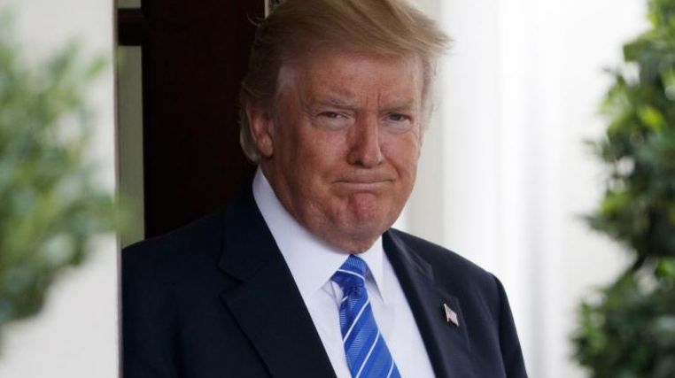 President Donald Trump waits outside the West Wing