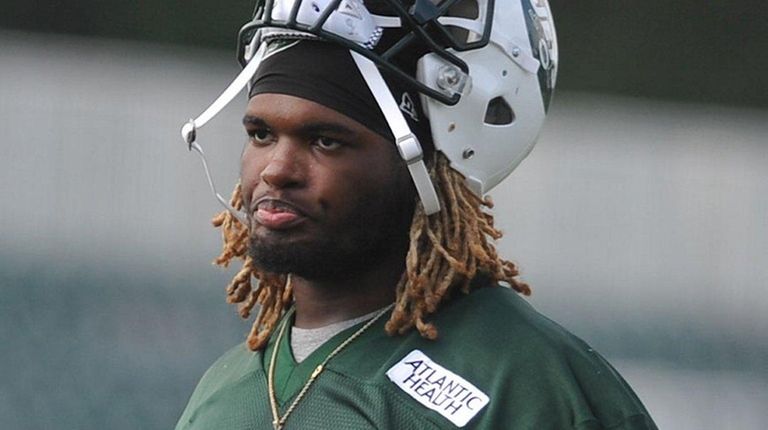 Lorenzo Mauldin heads off the field after Jets