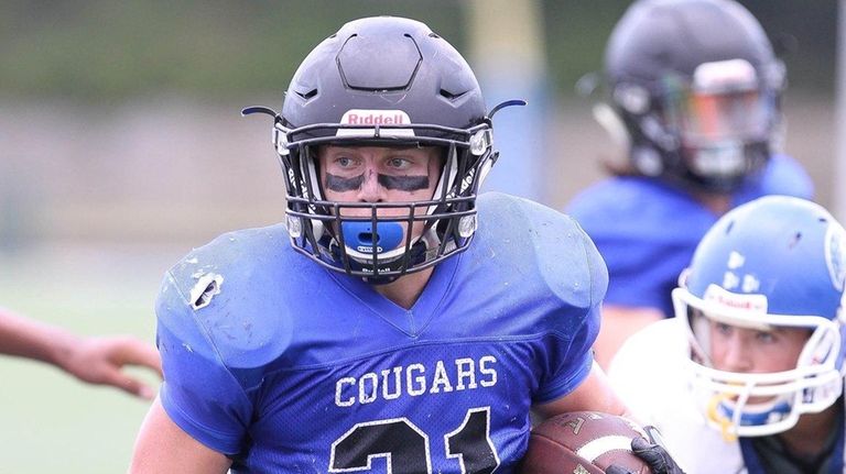 Centereach's Alec Kiernan (21) runs the ball in