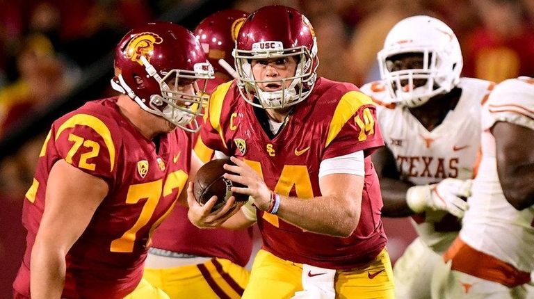 Sam Darnold of the USC Trojans scrambles away