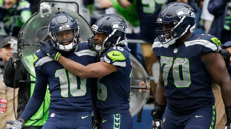 Seahawks wide receiver Paul Richardson, left, is greeted