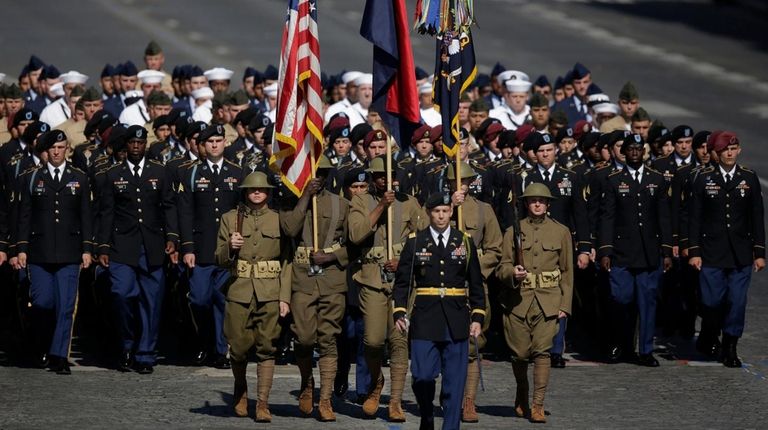 U.S troops march down the Champs Elysees during
