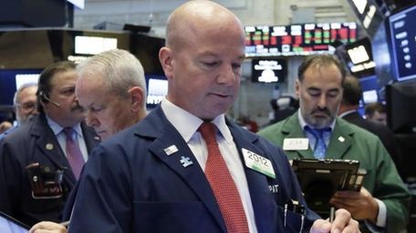 Trader Patrick Casey, center, works on the floor