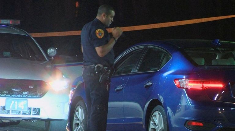 A Suffolk County police officer looks over a
