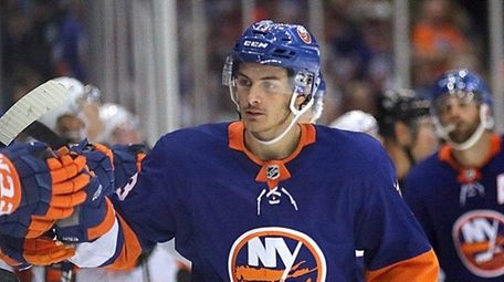 Islanders center Mathew Barzal (13) leads his team