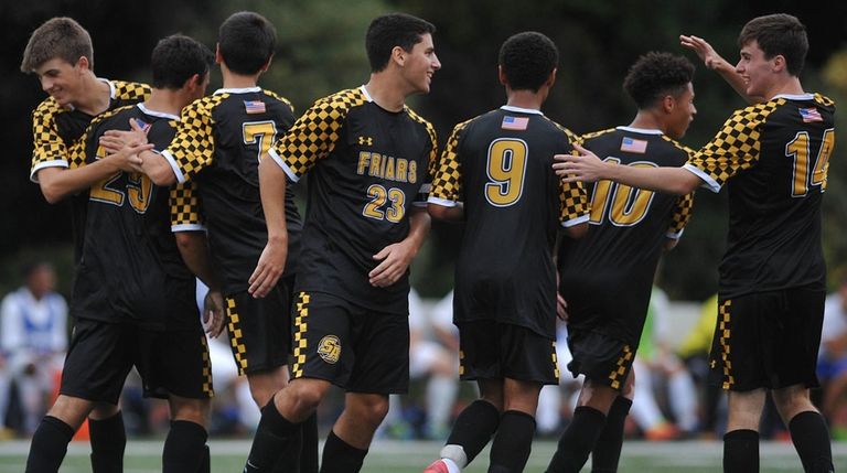 St. Anthony's teammates celebrate after a goal by