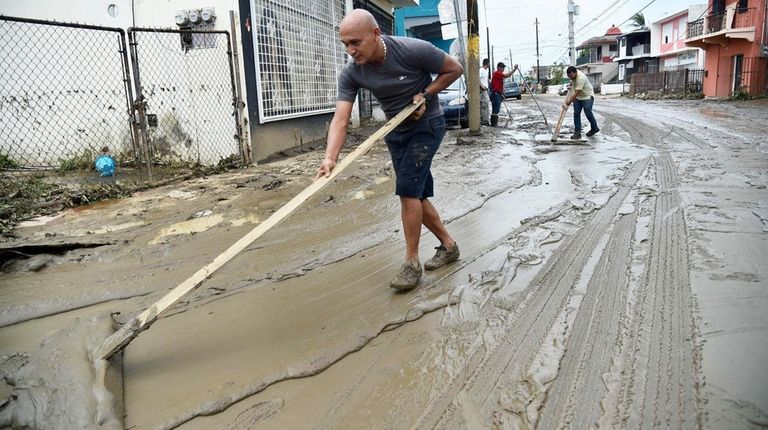 People clean the streets in Toa Baja, Puerto