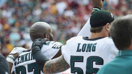 Eagles' Malcolm Jenkins and Chris Long react during