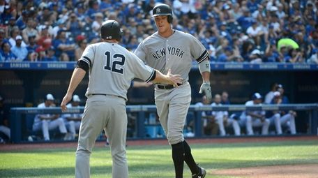 New York Yankees' Aaron Judge, right, celebrates at