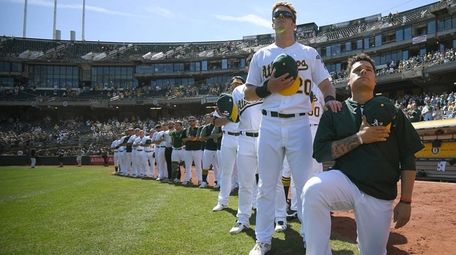 Bruce Maxwell of the Oakland Athletics kneels in