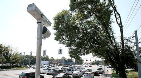 A red light camera on the corner of