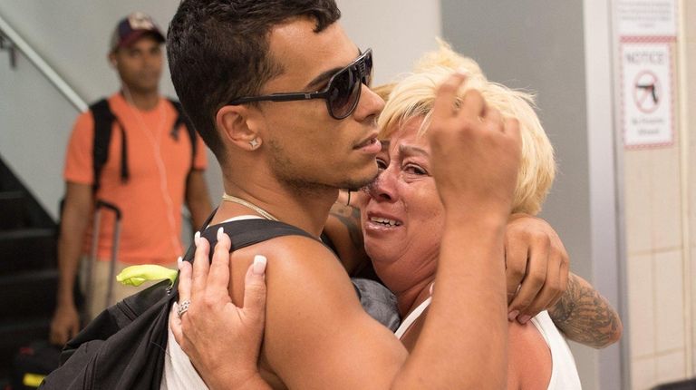Joseph Roman 24, of Levittown, gets a hug