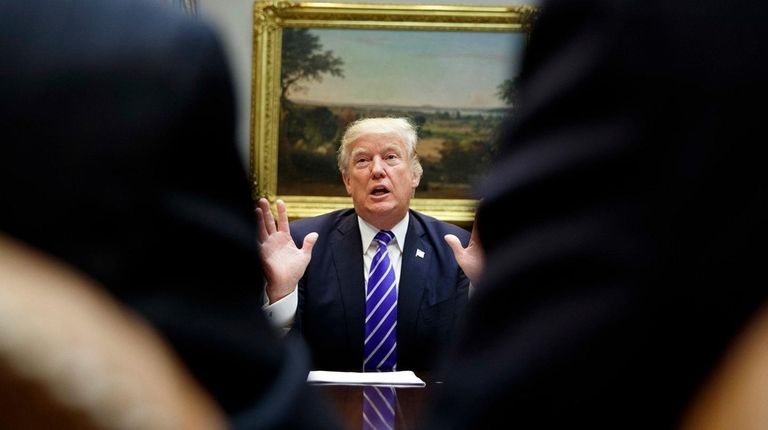 President Donald Trump speaks during a meeting with